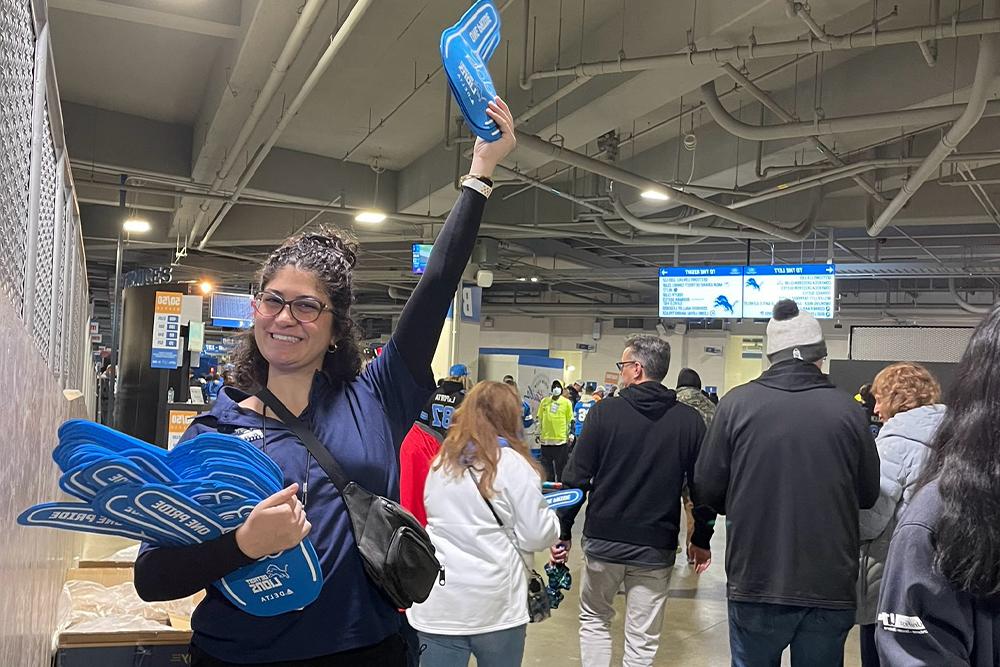 An image of an OUWB volunteer having fun at Ford Field